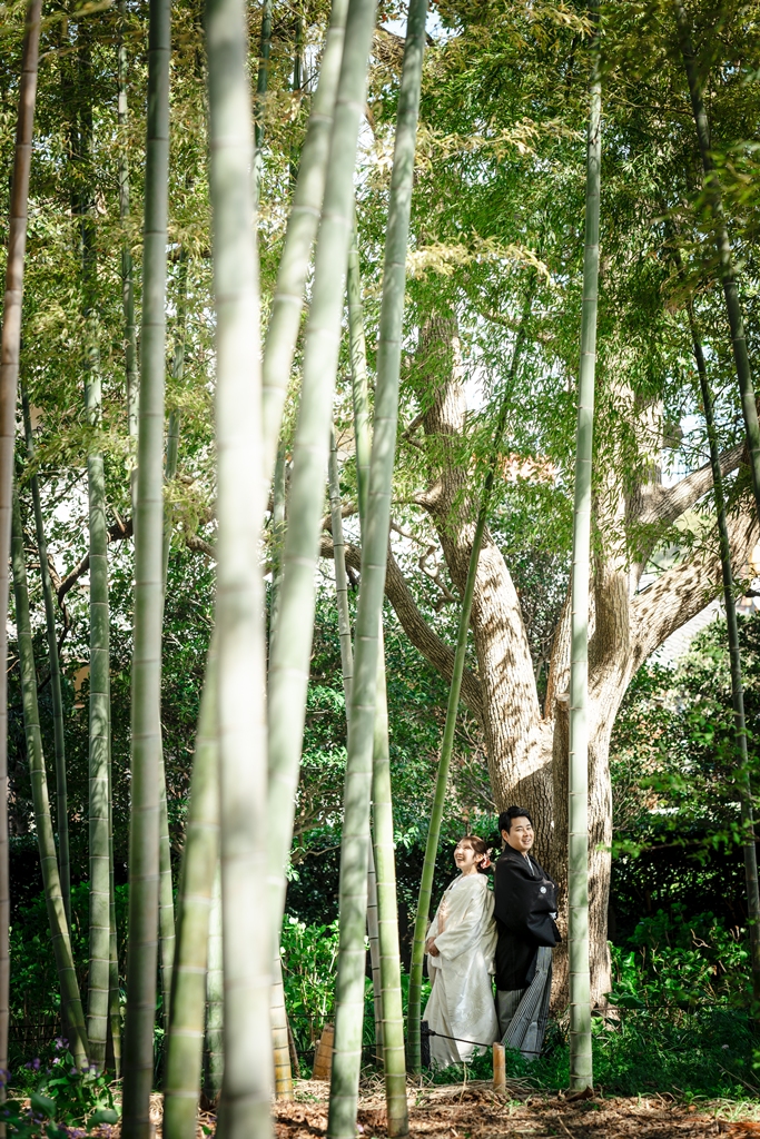 竹林の中で寄り添って立つ和装の新郎新婦